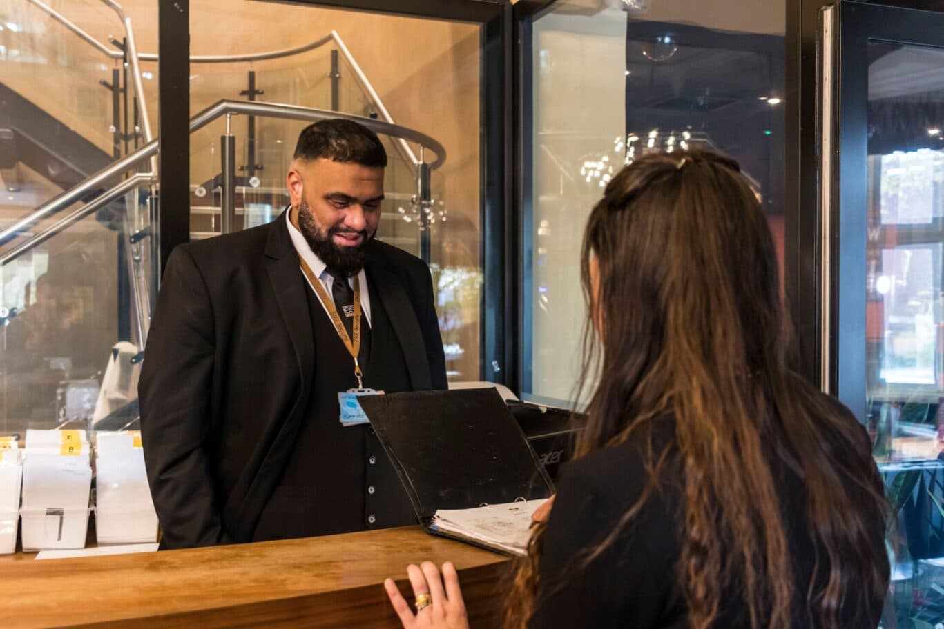Woman at reception desk talking to concierge